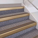 Satin Bronze double insert chevron stair nosing, 60mm riser with Brown inserts, fitted on carpeted stairs