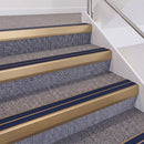 Satin Bronze double insert chevron stair nosing, 60mm riser with Dark Blue inserts, fitted on carpeted stairs