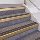 Satin Bronze double insert chevron stair nosing, 60mm riser with Dark Grey inserts, fitted on carpeted stairs
