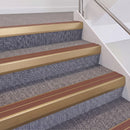 Satin Bronze double insert chevron stair nosing, 60mm riser with Mid Brown inserts, fitted on carpeted stairs