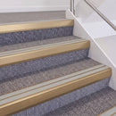 Satin Bronze double insert chevron stair nosing, 60mm riser with Oyster inserts, fitted on carpeted stairs
