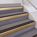 Satin Bronze double insert chevron stair nosing, 60mm riser with Premium Black inserts, fitted on carpeted stairs