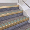 Satin Bronze double insert chevron stair nosing, 60mm riser with Sage Green inserts, fitted on carpeted stairs