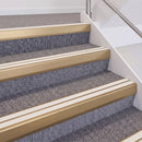 Satin Bronze double insert chevron stair nosing, 60mm riser with White inserts, fitted on carpeted stairs