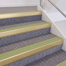 Satin Gold double insert chevron stair nosing, 60mm riser with Apple Green inserts, fitted on carpeted stairs