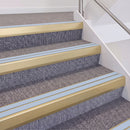 Satin Gold double insert chevron stair nosing, 60mm riser with Aura inserts, fitted on carpeted stairs