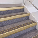 Satin Gold double insert chevron stair nosing, 60mm riser with Brown inserts, fitted on carpeted stairs