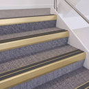 Satin Gold double insert chevron stair nosing, 60mm riser with Dark Grey inserts, fitted on carpeted stairs