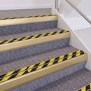 Satin Gold double insert chevron stair nosing, 60mm riser with Hazard black and yellow inserts, fitted on carpeted stairs