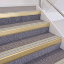 Satin Gold double insert chevron stair nosing, 60mm riser with Oyster inserts, fitted on carpeted stairs
