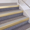 Satin Gold double insert chevron stair nosing, 60mm riser with Polar Grey inserts, fitted on carpeted stairs