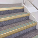Satin Gold double insert chevron stair nosing, 60mm riser with Sage Green inserts, fitted on carpeted stairs