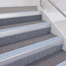 Satin Silver double insert chevron stair nosing, 60mm riser with Aura inserts, fitted on carpeted stairs