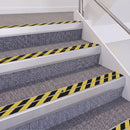 Satin Silver double insert chevron stair nosing, 60mm riser with Hazard black and yellow inserts, fitted on carpeted stairs