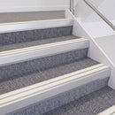 Satin Silver double insert chevron stair nosing, 60mm riser with White inserts, fitted on carpeted stairs