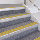 Satin Silver double insert chevron stair nosing, 60mm riser with Yellow inserts, fitted on carpeted stairs