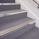 Bright Polished double insert chevron stair nosing, 70mm riser with Beige inserts, fitted on carpeted stairs