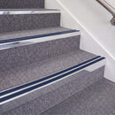 Bright Polished double insert chevron stair nosing, 70mm riser with Dark Blue inserts, fitted on carpeted stairs