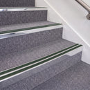 Bright Polished double insert chevron stair nosing, 70mm riser with Dark Green inserts, fitted on carpeted stairs