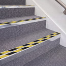 Bright Polished double insert chevron stair nosing, 70mm riser with Hazard black and yellow inserts, fitted on carpeted stairs