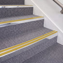 Bright Polished double insert chevron stair nosing, 70mm riser with Yellow inserts, fitted on carpeted stairs