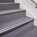 Dark Bronze double insert chevron stair nosing, 70mm riser with Aura inserts, fitted on carpeted stairs