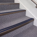 Dark Bronze double insert chevron stair nosing, 70mm riser with Dark Blue inserts, fitted on carpeted stairs