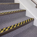 Dark Bronze double insert chevron stair nosing, 70mm riser with Hazard black and yellow inserts, fitted on carpeted stairs