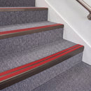 Dark Bronze double insert chevron stair nosing, 70mm riser with Red inserts, fitted on carpeted stairs