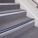 Mill Finish double insert chevron stair nosing, 70mm riser with Dark Blue inserts, fitted on carpeted stairs