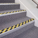 Mill Finish double insert chevron stair nosing, 70mm riser with Hazard black and yellow inserts, fitted on carpeted stairs