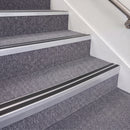 Mill Finish double insert chevron stair nosing, 70mm riser with Premium Black inserts, fitted on carpeted stairs