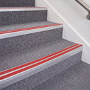 Mill Finish double insert chevron stair nosing, 70mm riser with Red inserts, fitted on carpeted stairs