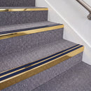 Mirrorflect Gold double insert chevron stair nosing, 70mm riser with Dark Blue inserts, fitted on carpeted stairs