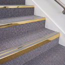 Mirrorflect Gold double insert chevron stair nosing, 70mm riser with Polar Grey inserts, fitted on carpeted stairs