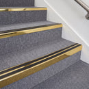 Mirrorflect Gold double insert chevron stair nosing, 70mm riser with Premium Black inserts, fitted on carpeted stairs