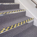 Mirrorflect Silver double insert chevron stair nosing, 70mm riser with Hazard black and yellow inserts, fitted on carpeted stairs