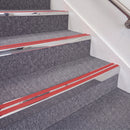 Mirrorflect Silver double insert chevron stair nosing, 70mm riser with Red inserts, fitted on carpeted stairs