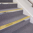 Mirrorflect Silver double insert chevron stair nosing, 70mm riser with Yellow inserts, fitted on carpeted stairs
