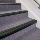 Satin Black double insert chevron stair nosing, 70mm riser with Dark Green inserts, fitted on carpeted stairs