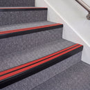 Satin Black double insert chevron stair nosing, 70mm riser with Red inserts, fitted on carpeted stairs