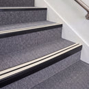 Satin Black double insert chevron stair nosing, 70mm riser with White inserts, fitted on carpeted stairs