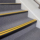 Satin Black double insert chevron stair nosing, 70mm riser with Yellow inserts, fitted on carpeted stairs