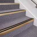 Satin Bronze double insert chevron stair nosing, 70mm riser with Premium Black inserts, fitted on carpeted stairs