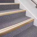 Satin Bronze double insert chevron stair nosing, 70mm riser with White inserts, fitted on carpeted stairs