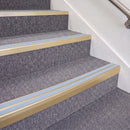 Satin Gold double insert chevron stair nosing, 70mm riser with Aura inserts, fitted on carpeted stairs