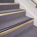 Satin Gold double insert chevron stair nosing, 70mm riser with Dark Blue inserts, fitted on carpeted stairs