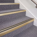 Satin Gold double insert chevron stair nosing, 70mm riser with Dark Grey inserts, fitted on carpeted stairs