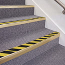 Satin Gold double insert chevron stair nosing, 70mm riser with Hazard black and yellow inserts, fitted on carpeted stairs