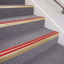Satin Gold double insert chevron stair nosing, 70mm riser with Red inserts, fitted on carpeted stairs
